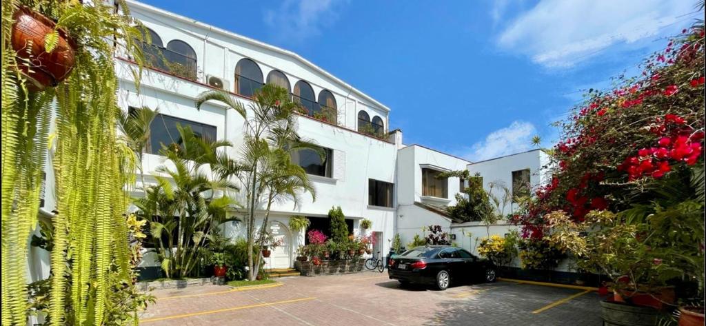 a car parked in a parking lot in front of a building at Casa Bella Boutique Hotel San Isidro in Lima