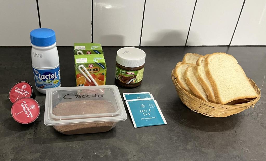 una mesa con una cesta de pan y un sándwich en Appartements T2, en Vourles