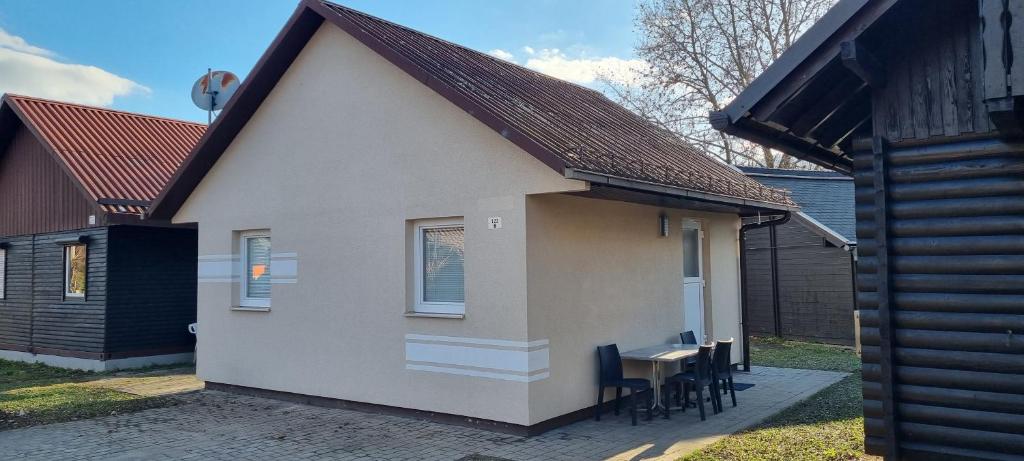 a small house with a table and some chairs at Time4you in Čatež ob Savi