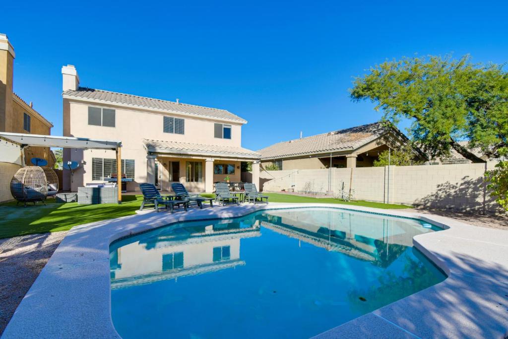 a swimming pool in front of a house at Spacious Scottsdale Home with Private Heated Pool in Scottsdale
