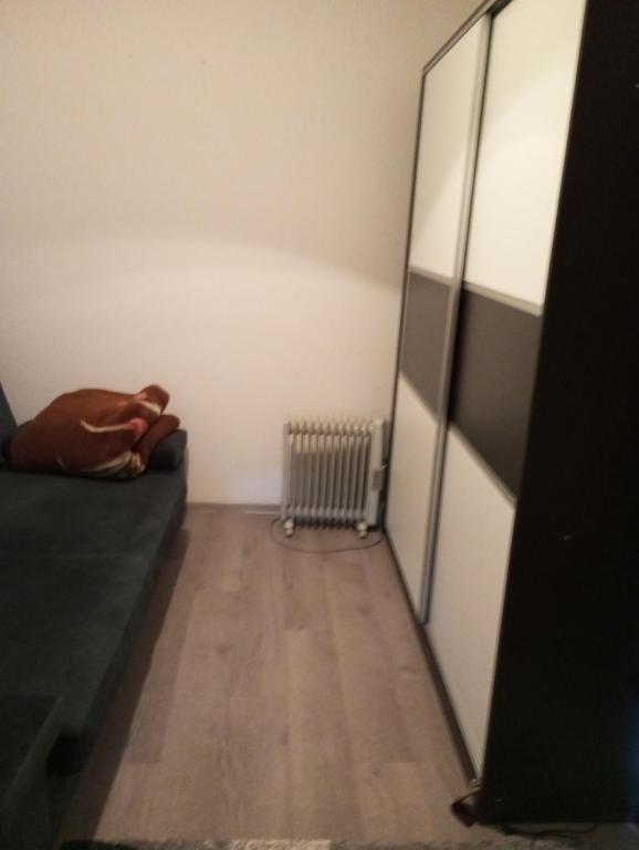 a person laying on a bed in a room at Apartman Old Town in Stolac