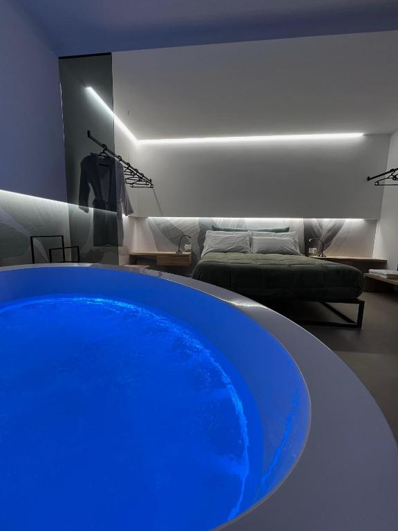 a blue tub in a living room with a couch at Seacity Suite & Stay in Monopoli