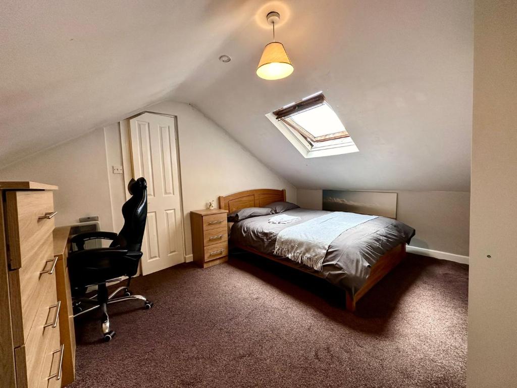 a bedroom with a bed and a desk and a chair at Spacious Room in Dublin in Dublin