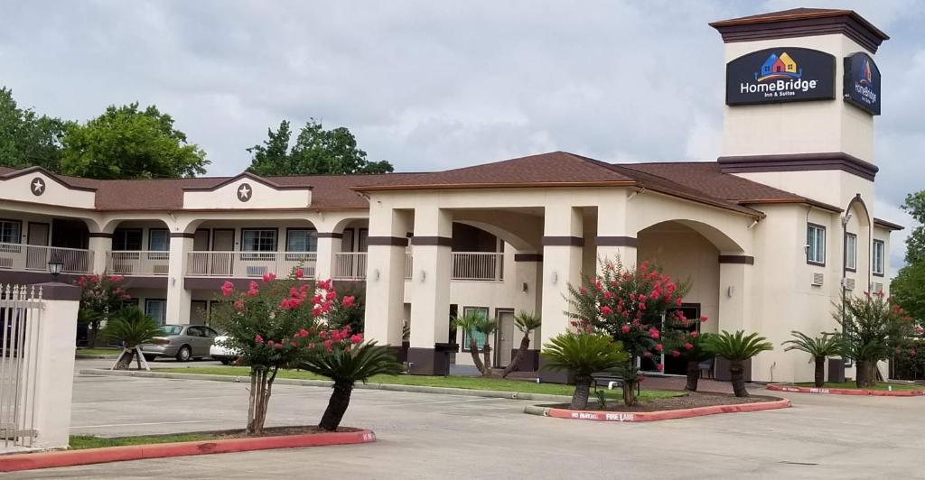 a large building with a clock tower on top of it at HomeBridge Inn and Suites in Beaumont