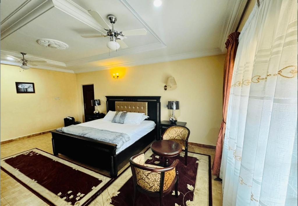 a bedroom with a bed and a ceiling fan at Silent night in Kumasi