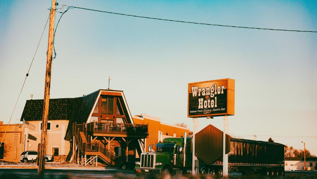un camion parcheggiato di fronte a un edificio con un cartello di Wrangler Inn Mobridge a Mobridge