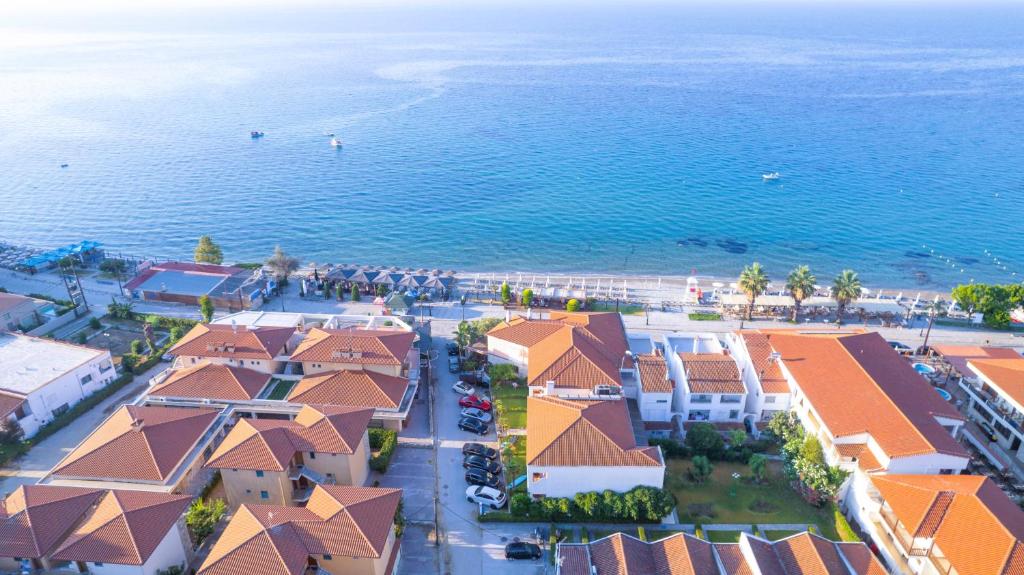 an aerial view of a beach with houses and the ocean at Hotel Paralio in Possidi