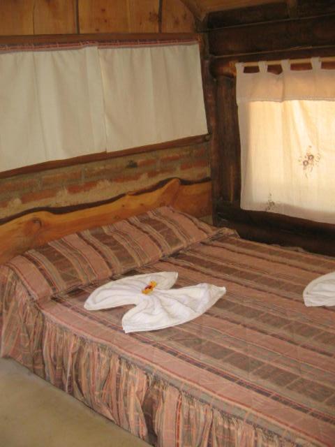 Postel nebo postele na pokoji v ubytování SENCILLAMENTE CABAÑAS