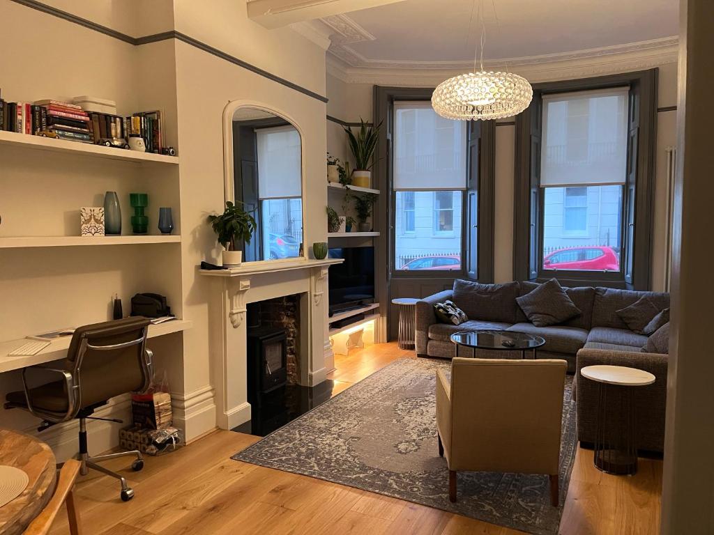 a living room with a couch and a fireplace at Kemp Town apartment in Brighton & Hove