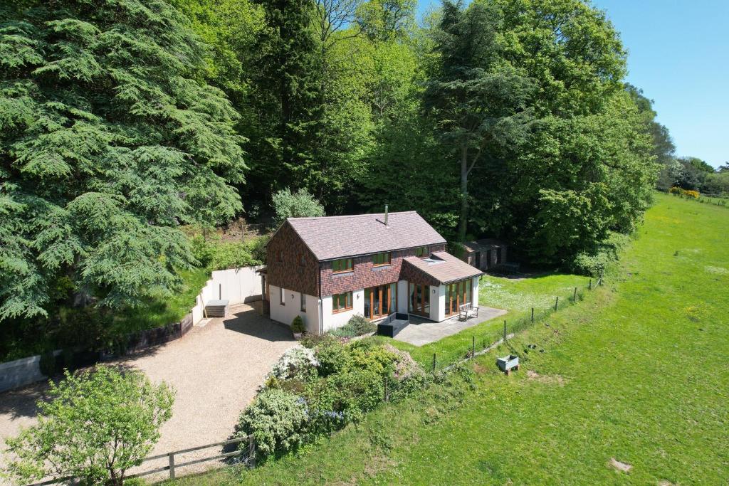 an aerial view of a small house in a field at Holly Cottage, Surrey Hills in Cranleigh