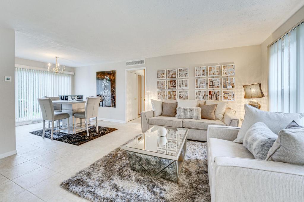 a living room with a couch and a table at Family-Friendly Bloomfield Hills Home with Patio! in Bloomfield Hills