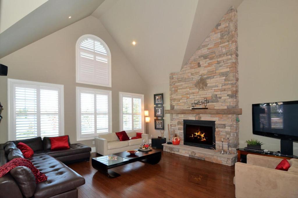 a living room with a couch and a fireplace at Beautiful ski chalet in the blue mountains with gas fireplace and community pool in Collingwood