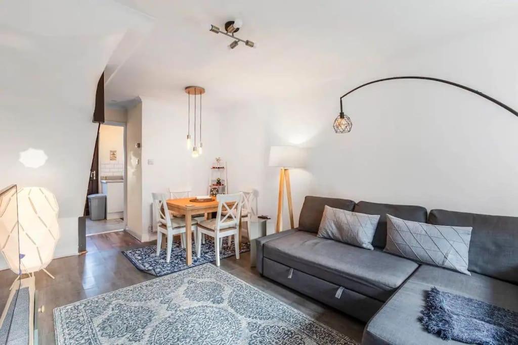 a living room with a couch and a table at Quiet & Secluded St Albans House in Saint Albans