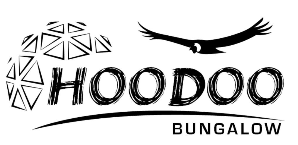 a black bird flying over the word hollywood at Bungalow Hoodoo in Melipeuco