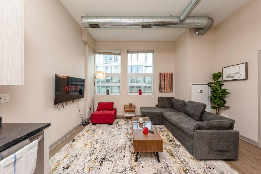 a living room with a couch and a table at McCormick 2br/2ba Oasis with optional Parking, Patio, Gym for up to 6 guests in Chicago