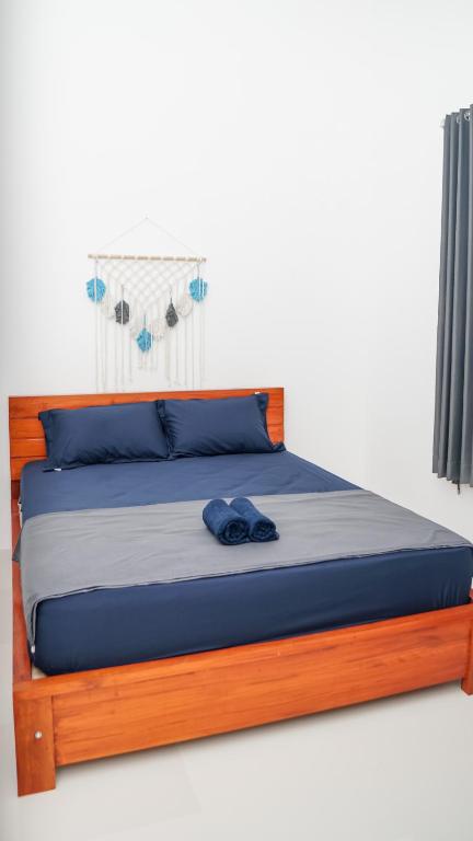 Postel nebo postele na pokoji v ubytování Wangi Homestay