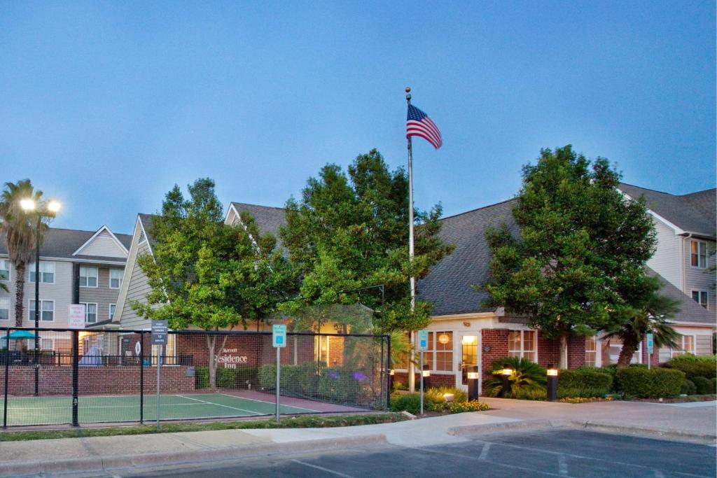 an american flag on a tennis court in front of a building at Residence Inn by Marriott Austin Round Rock/Dell Way in Round Rock