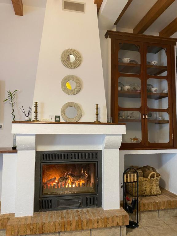 a fireplace in a living room with a fire place at La Casa del San Antón in Níjar