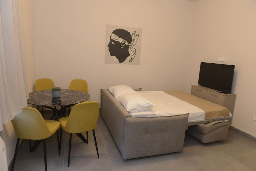a hospital room with a bed and a table and chairs at Apartment Dora 3,beach apartment in Tivat