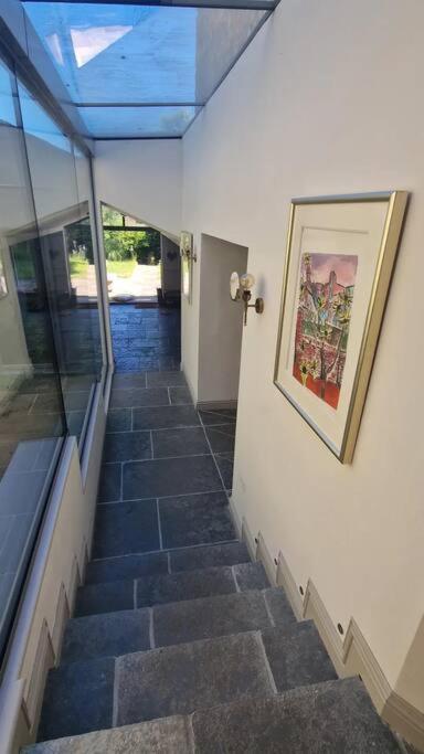 a staircase in a building with a painting on the wall at High street, Bruton in Bruton