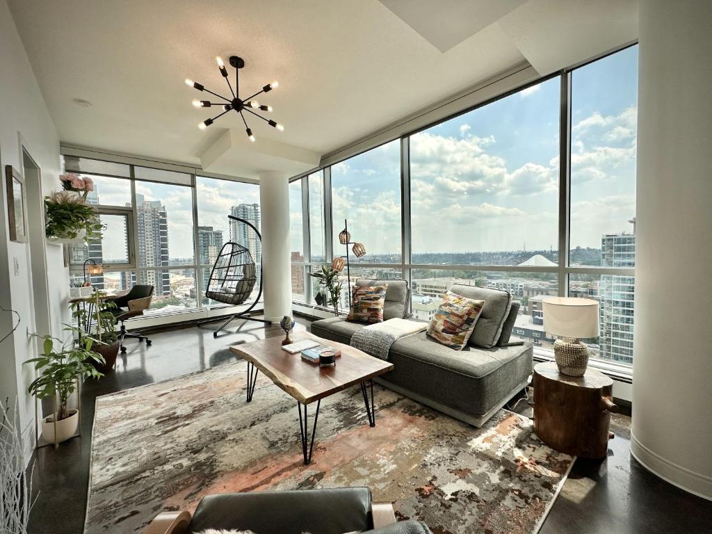 a living room with a view of a city at ColoursNest - Downtown apt spectacular view and location in Calgary