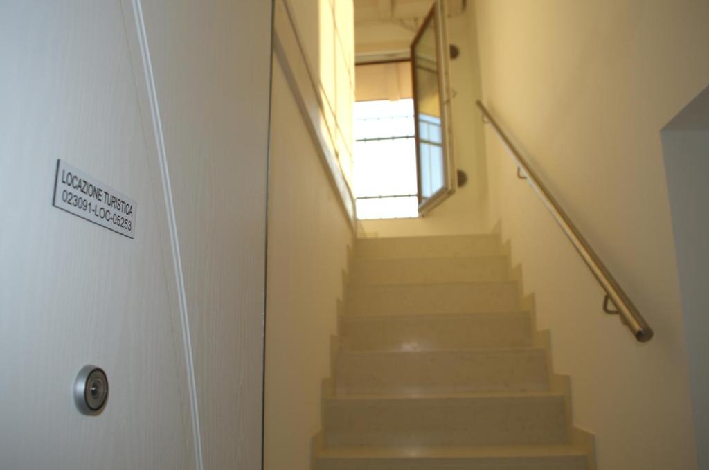 a hallway with stairs with a door and a window at Locazione Turistica Aquila in Verona