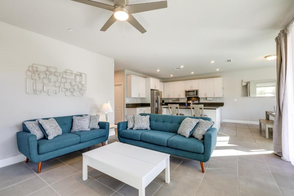 a living room with two blue couches and a table at Stylish Lodi Wine Country Retreat with Private Patio in Lodi