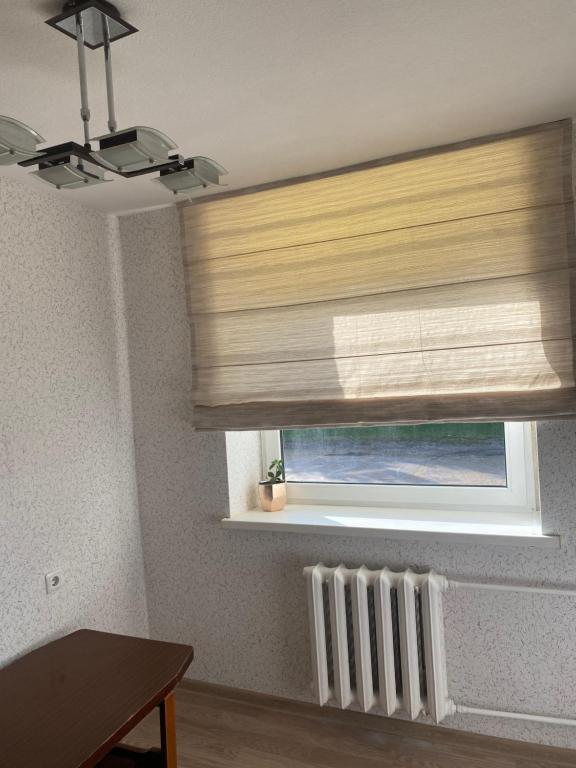 a window with a blind in a room at Mini room in Kėdainiai
