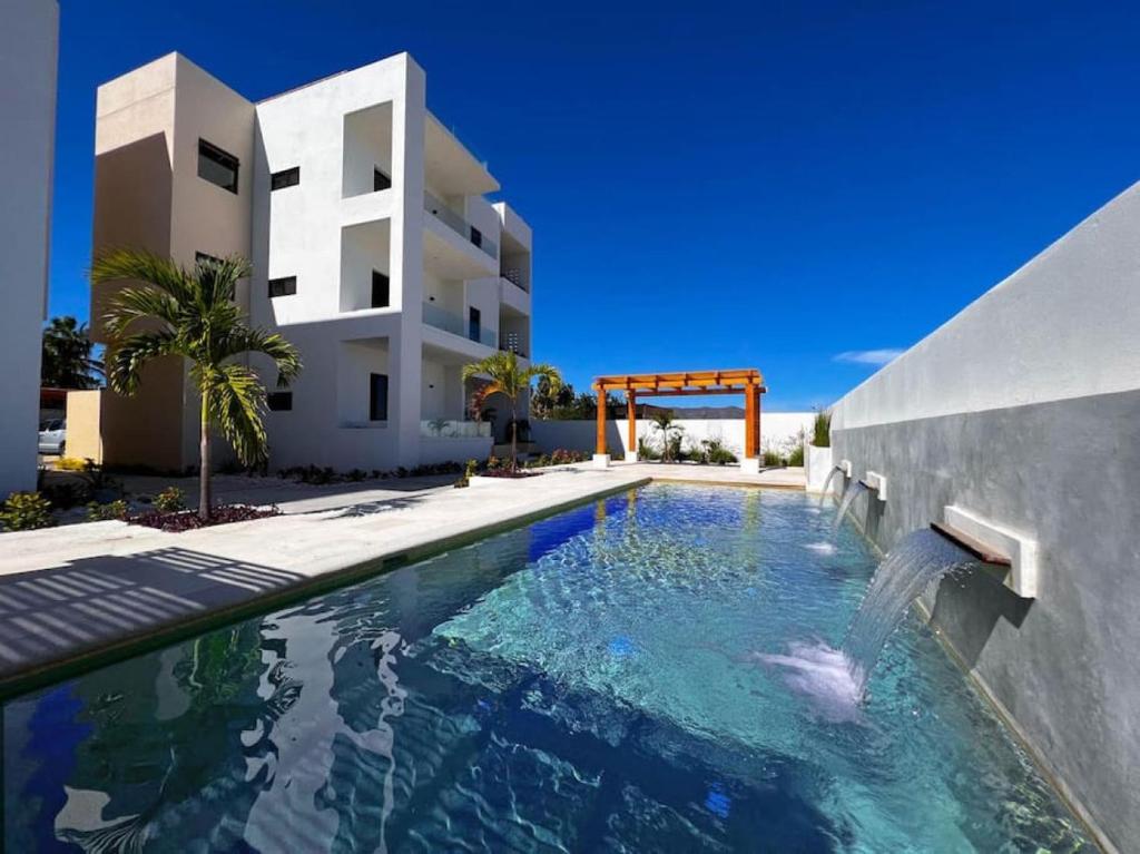 a swimming pool in front of a house at Pool Condo, just a few steps from the beach -north in Los Barriles