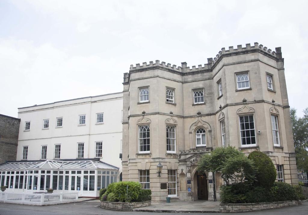a large brick building with a large window at Arnos Manor Hotel in Bristol