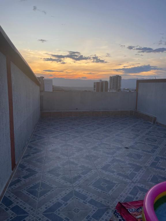 a balcony with a view of the sunset on a roof at Crisana - jerez in Floridablanca