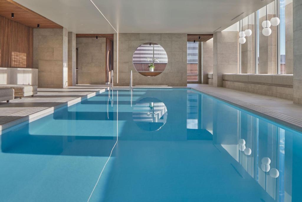 a swimming pool with blue water in a building at The St. Regis San Francisco in San Francisco