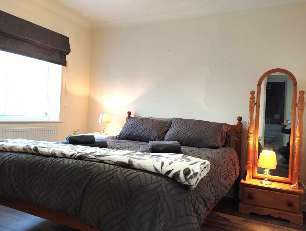 1 dormitorio con cama, espejo y cama sidx sidx sidx sidx en Comfort Private Rooms in Three bedroom House en Bridgemary