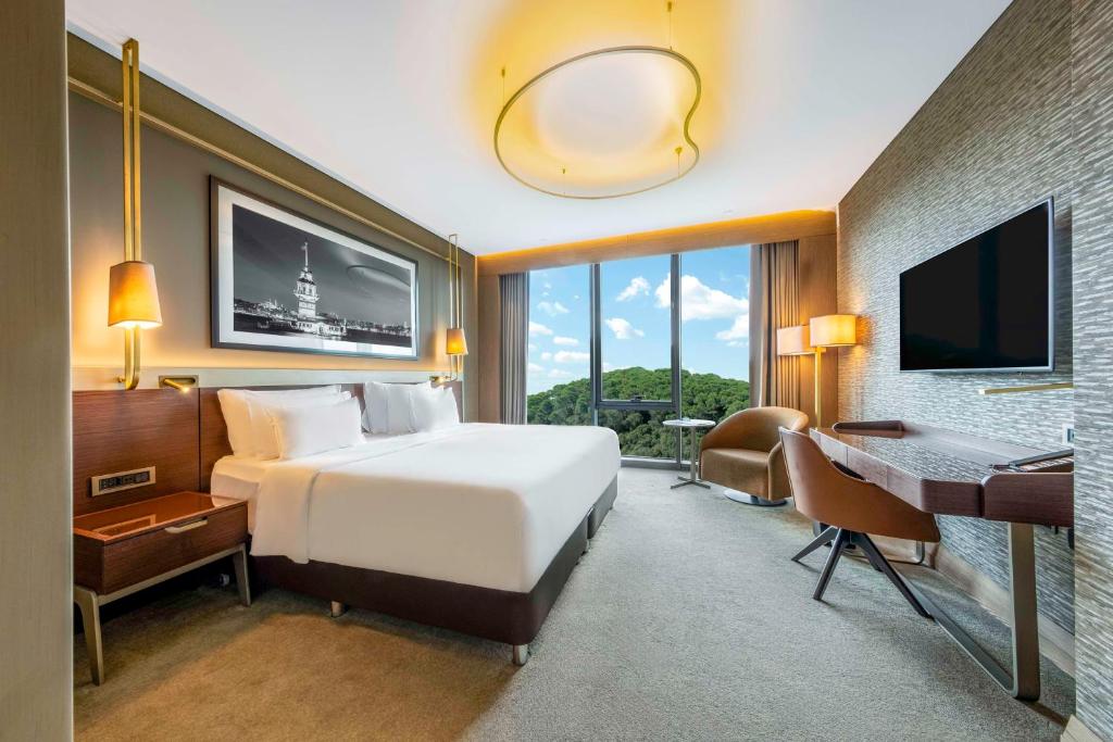 a bedroom with a bed and a desk and a computer at Radisson Collection Hotel, Vadistanbul in Istanbul
