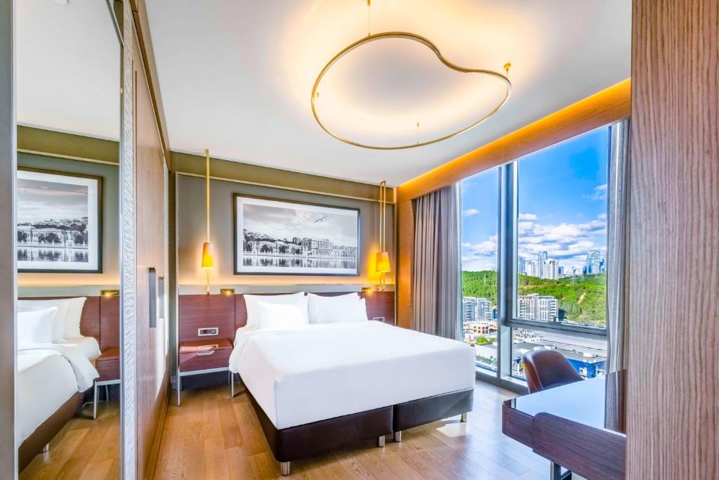 a hotel room with two beds and a large window at Radisson Collection Hotel, Vadistanbul in Istanbul