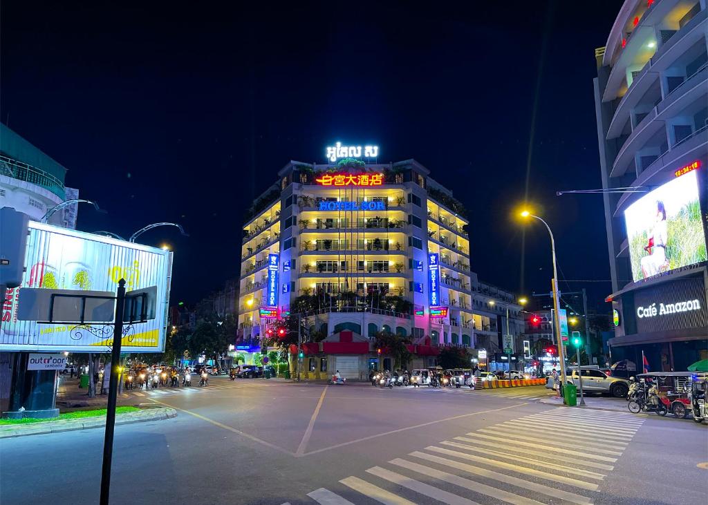 a building with a neon sign on it at night at Hotel Sor in Phnom Penh
