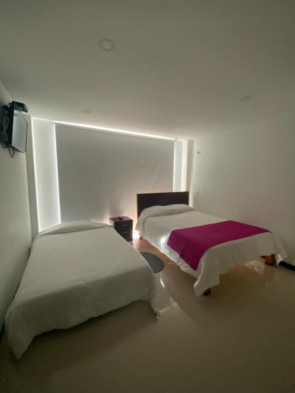 Postel nebo postele na pokoji v ubytování Hotel Campestre Villa Juliana