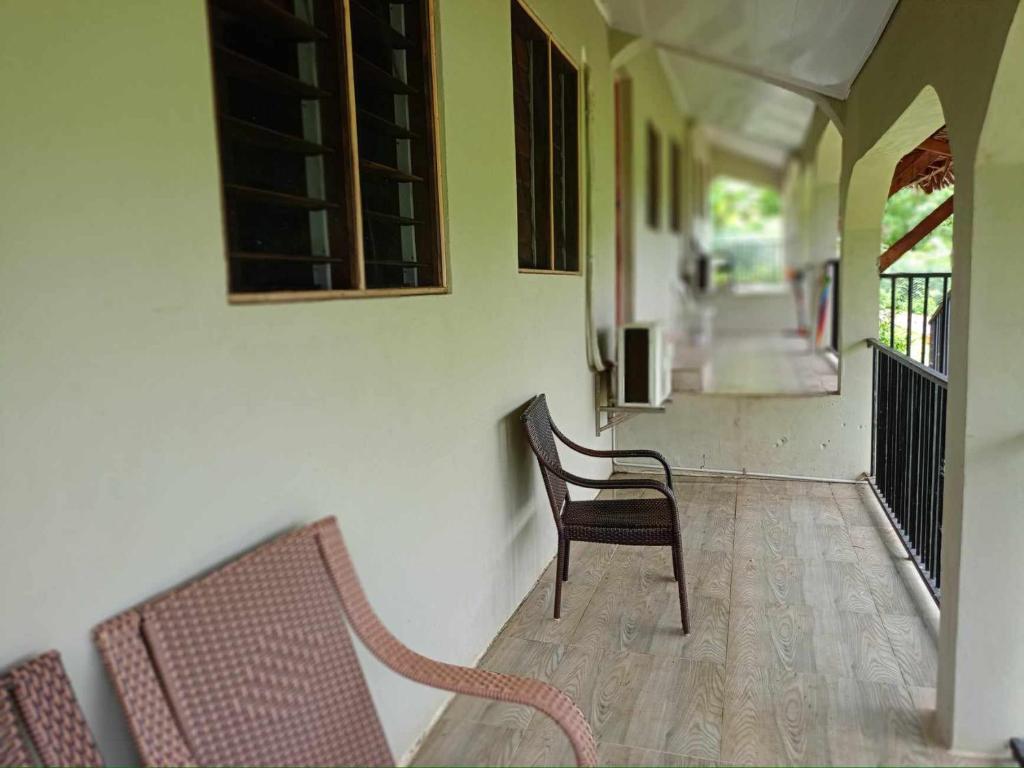 a room with two chairs and a hallway at Tias appartment in Port Vila