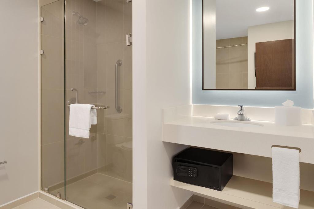 a bathroom with a sink and a shower at Courtyard by Marriott San Jose Airport Alajuela in Alajuela City