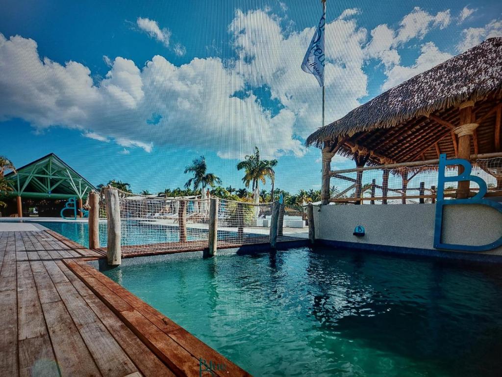 a swimming pool at a resort with a building at MANBANA 320 RESIDENCE KAWANN in Grand-Bourg