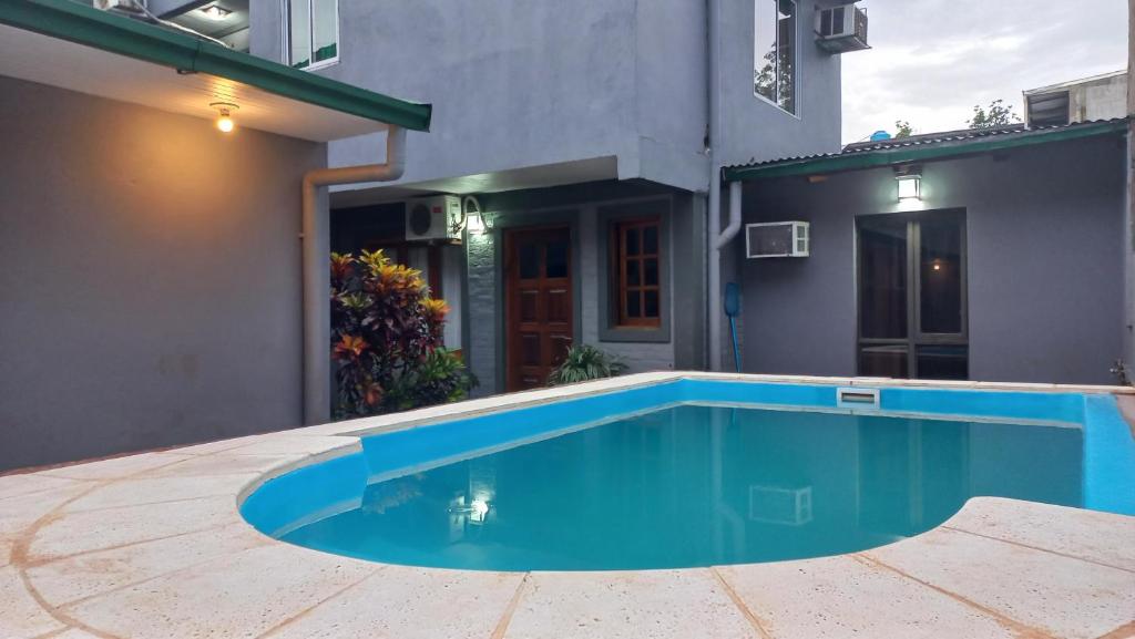 a swimming pool in front of a house at Rinconcito Iguazú in Puerto Iguazú