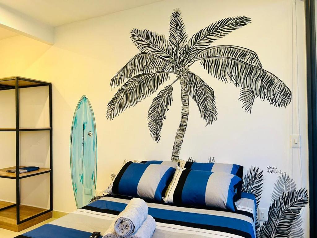 a bedroom with a palm tree stenciled on the wall at Salinas Del Mar - Pozos Colorados - By INMOBILIARIA VS in Santa Marta