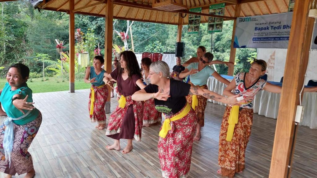 a group of people dancing on a dance floor at Pinge Traditional Village in Petang
