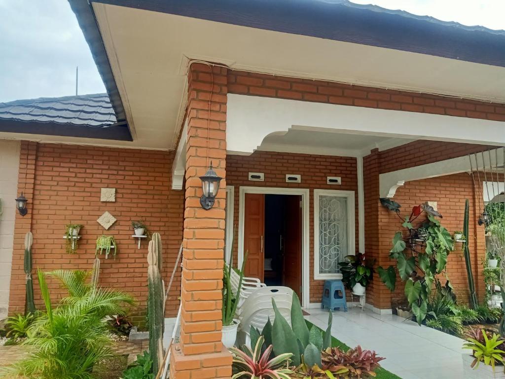 a brick house with a large glass door at Nanita Homestay in Talun