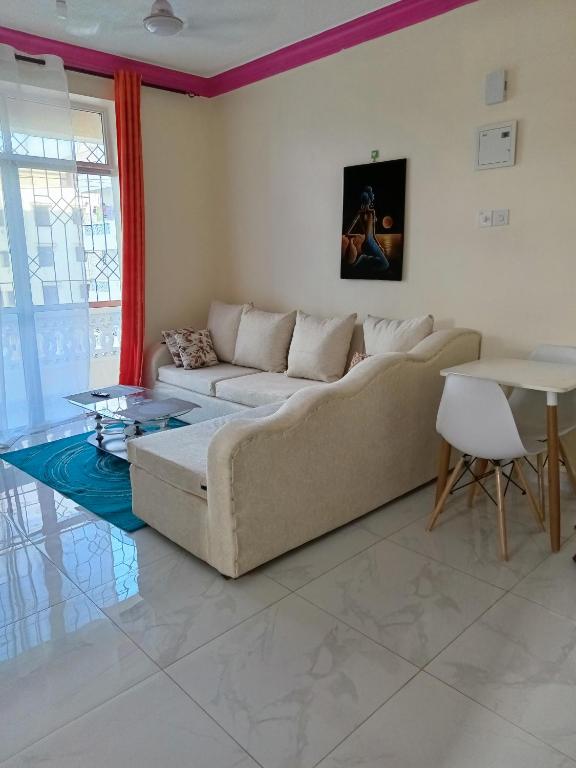 a living room with a couch and a table at ROYAL APARTMENT MAKUPA in Mombasa