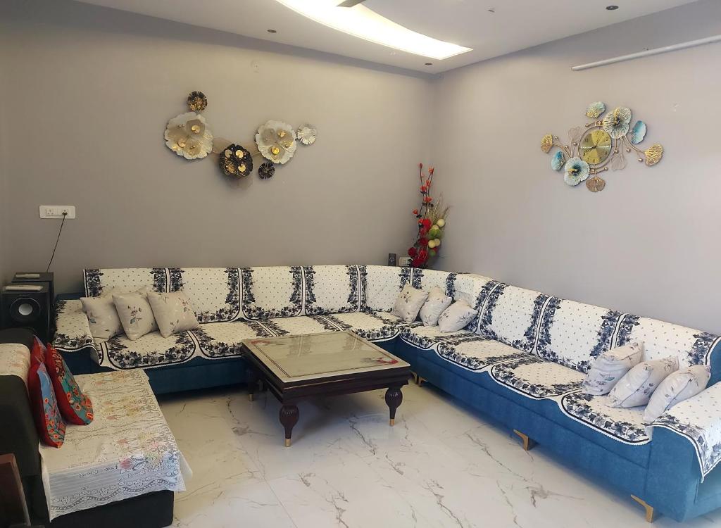 a living room with a blue and white couch at Aradhyas Stay in Jaipur