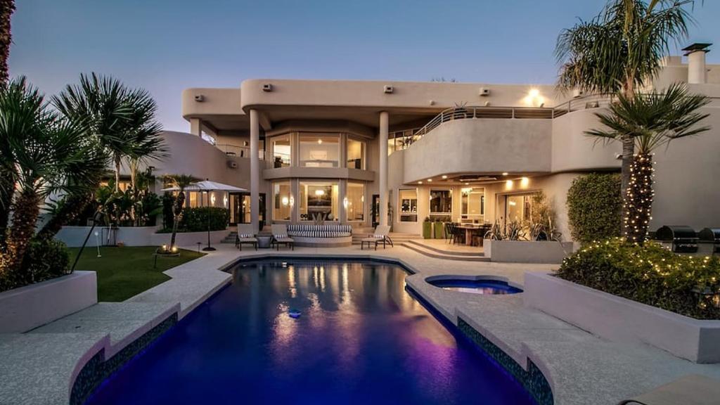 a large house with a swimming pool in front of it at Stunning Private and Modern N Scottsdale Estate in Scottsdale