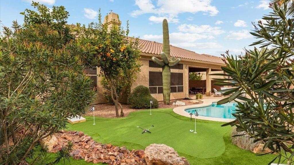 an image of a house with a yard with a pool at Southwestern 4 Bdrm Retreat HTD Pool Game Room in Phoenix