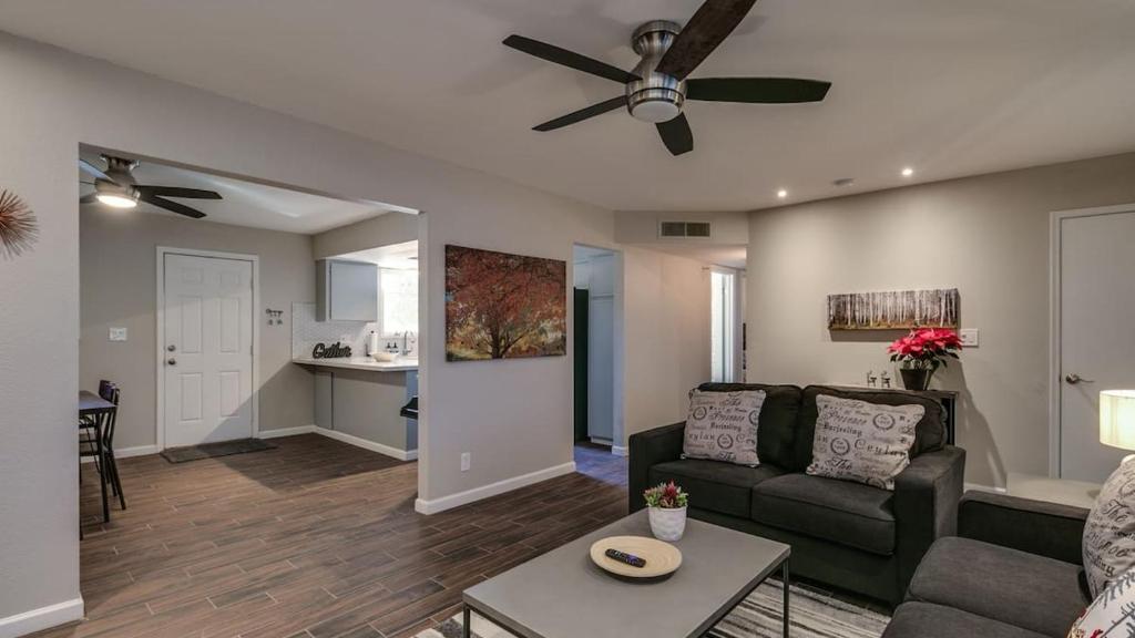 a living room with a couch and a ceiling fan at Remodeled Tempe Home in Prime Location in Tempe