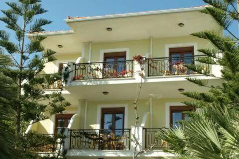 a large white building with windows and balconies at Patras Apartments Marilia and Konstantinos in Poseidónion